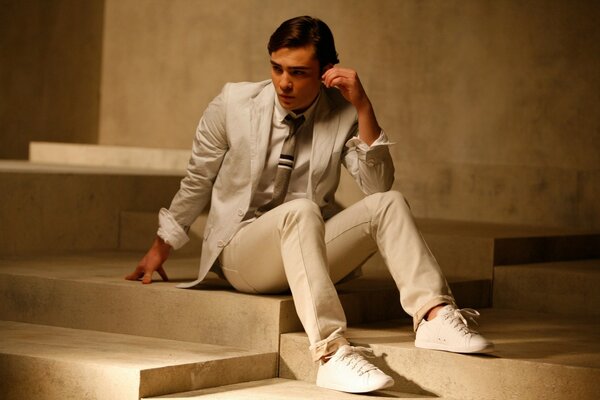 Thoughtful man in a white suit