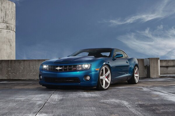 The blue Chevrolet looks great against the background of concrete