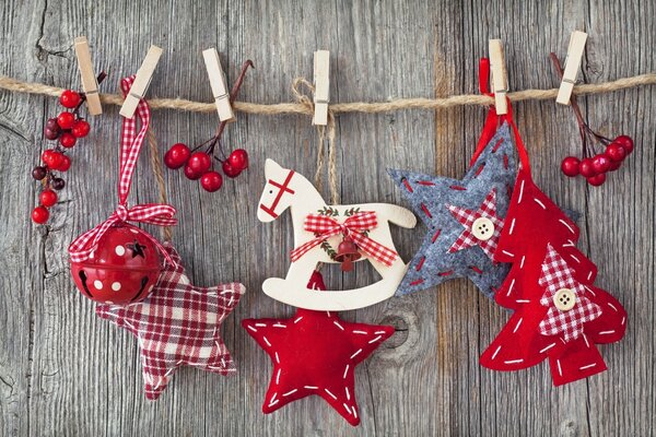 Wooden horse, fabric stars and a Christmas tree suspended on a rope