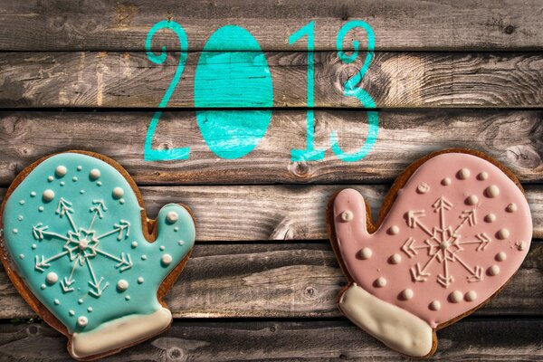 New Year s mood. Gingerbread cookies in the shape of mittens on a beautiful background
