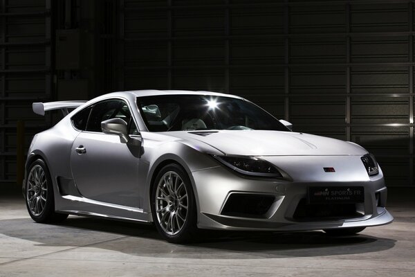 A white tuned Porsche in the garage