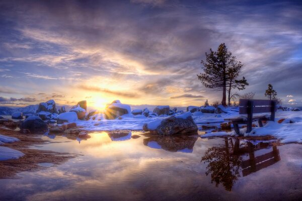 Winter sunset with the reflection of the sun in the water