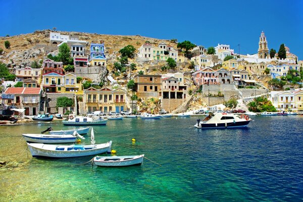 Harbor with boats and houses in Greece