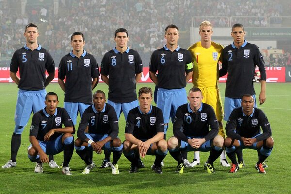 A team of rugby players in black and blue uniforms