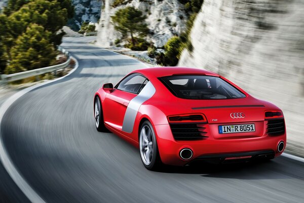 Red sports car on a narrow winding road