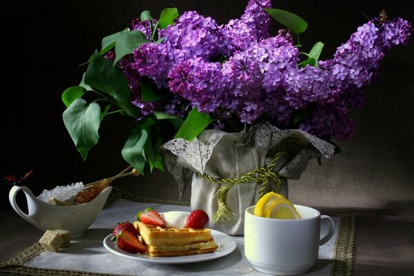 Delicious still life with lilac flowers and tea