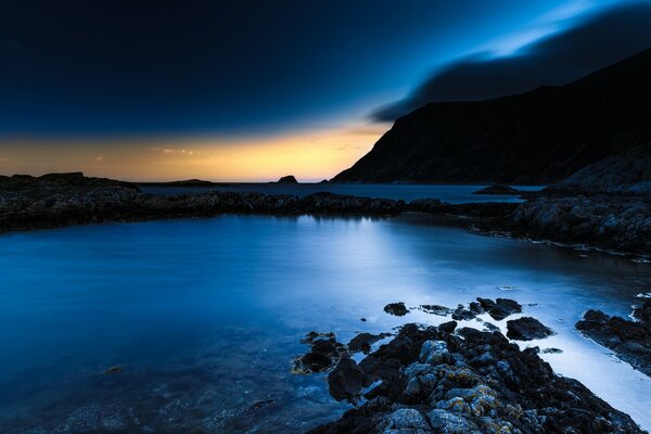 Twilight on the background of the sea and mountains