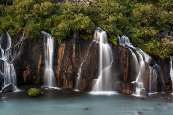 Several waterfalls and green trees