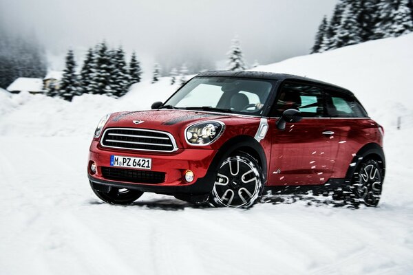 Mini cooper skidding on a snowy road