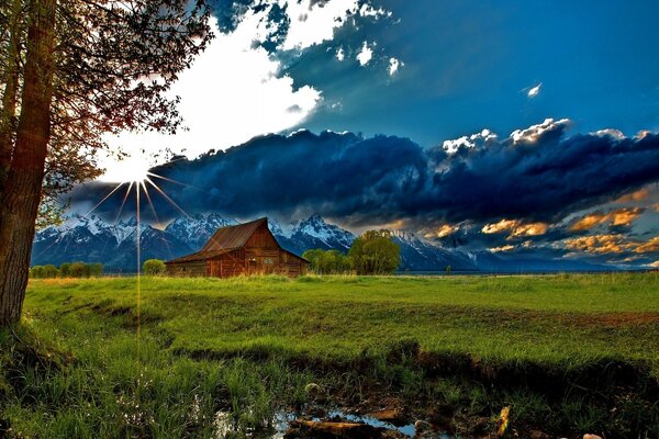 Incredible clouds surrounded the grass field