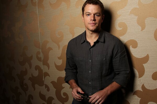 Matt Damon is standing by the wall