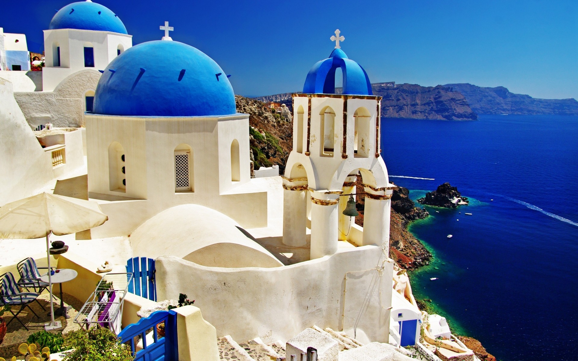 greece architecture travel sea outdoors sky seashore vacation caldera traditional water dome building summer tourism church city blue sky mountains landscape