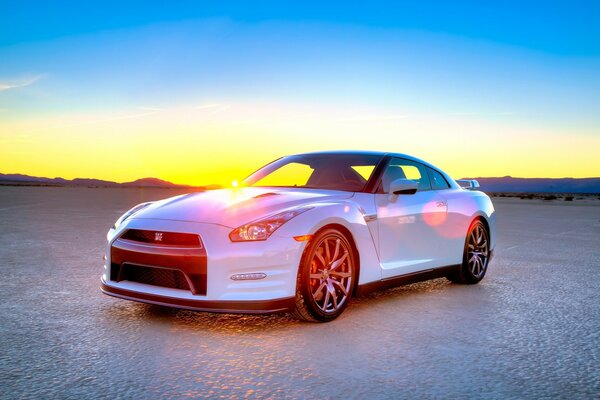 Beautiful sunset with a white car