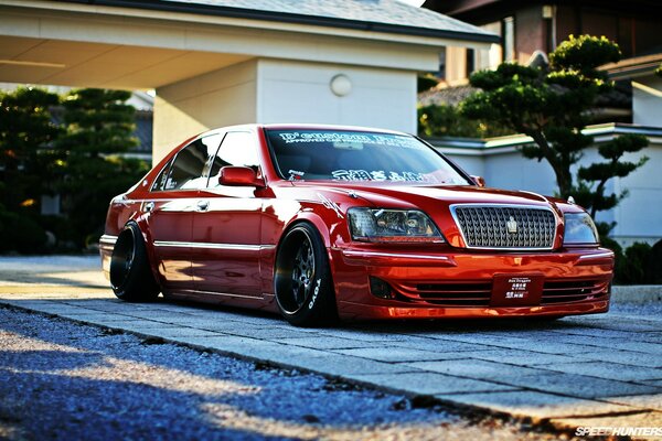 A red car tuned for a sports car on the track