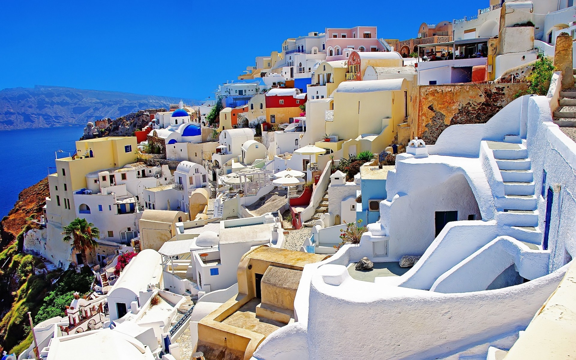 greece sea travel architecture seashore city resort chair vacation tourism house island outdoors town building sky cliff exotic tropical mediteranian