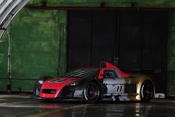 A brutal car on the background of a hangar