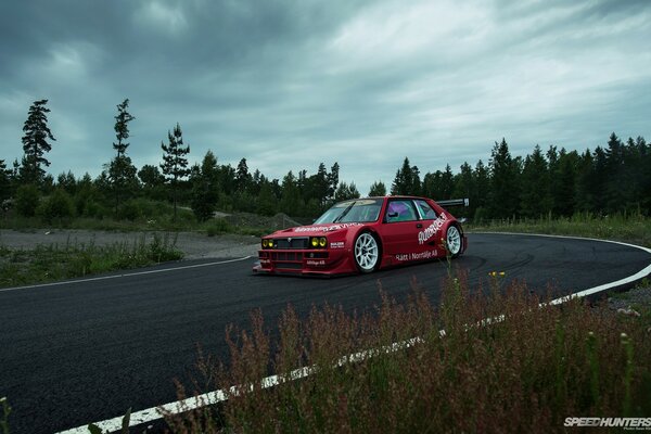 Racing red car on the turn