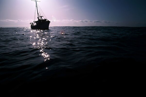 Sunset in summer in the ocean. watercraft on the water