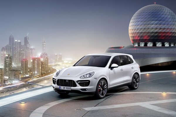 Белая porsche cayenne возле вертолётной площадки