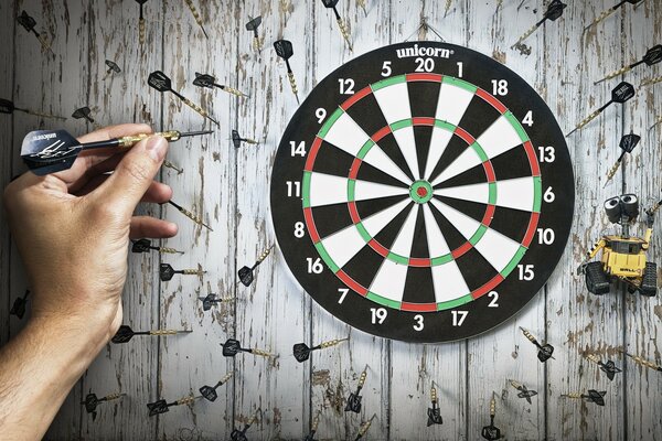 A game of darts on a wooden background