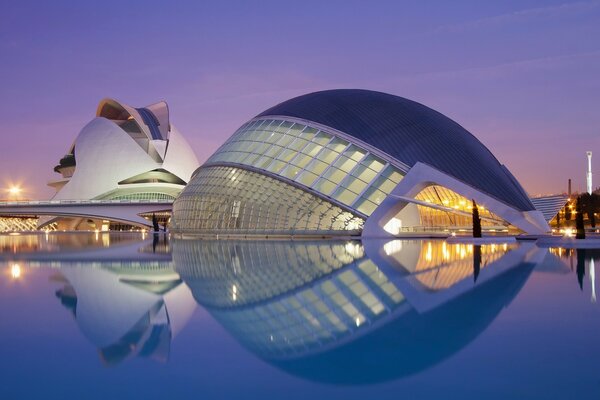 An architectural object is reflected in the water