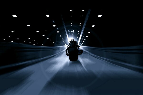 沿着黑色隧道飞行，沿着罕见的灯笼，一个摩托车手
