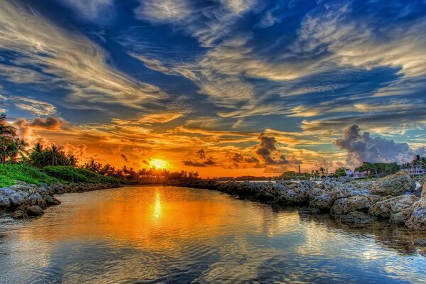 Cloudy sky. Sunset on the water