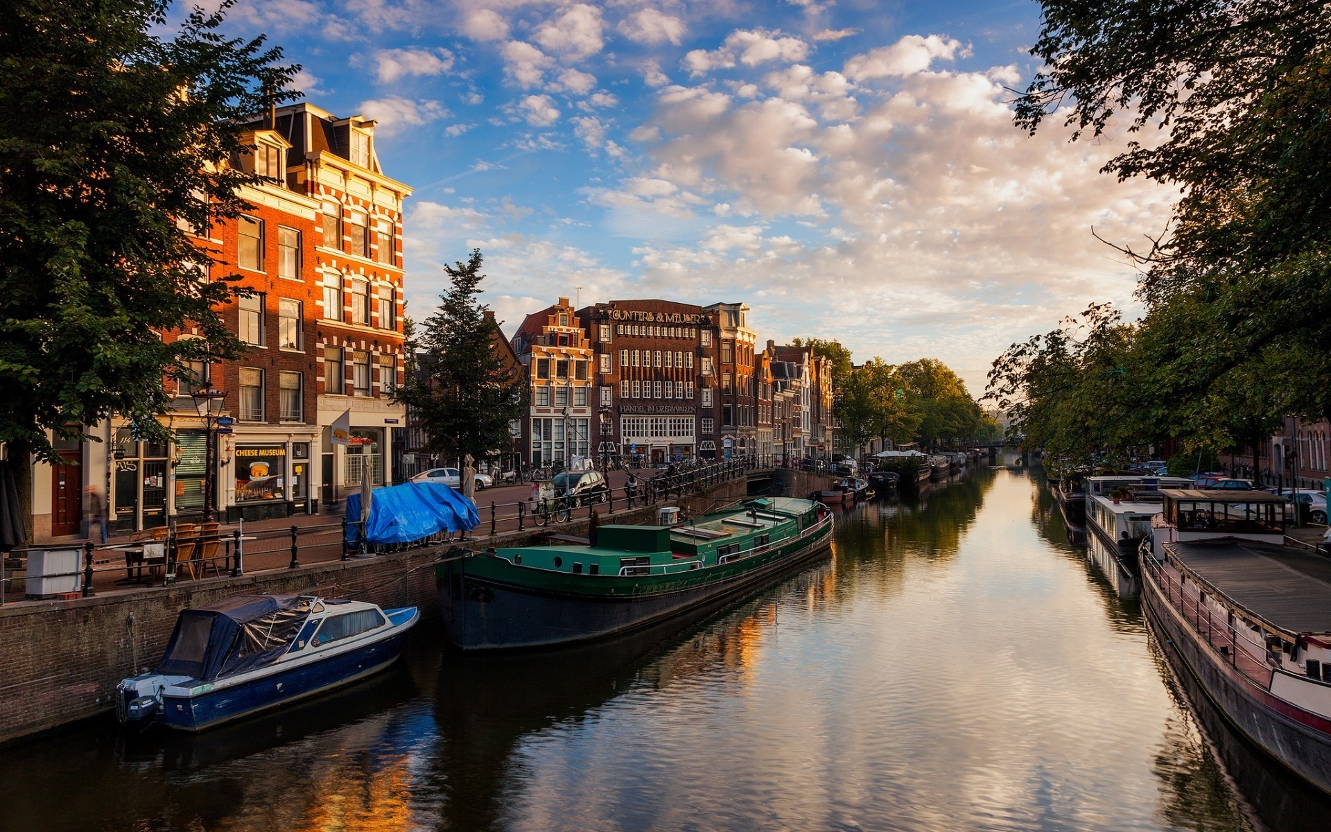 other city water canal river boat travel reflection city watercraft outdoors architecture bridge sky transportation system amsterdam