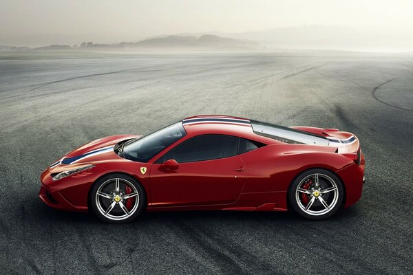 Red Ferrari in foggy terrain