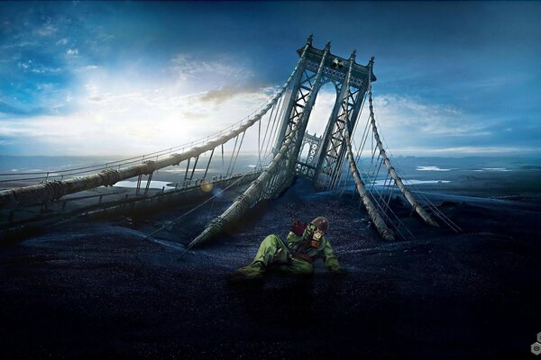 Image of a fallen bridge into the ocean on the background of sunset