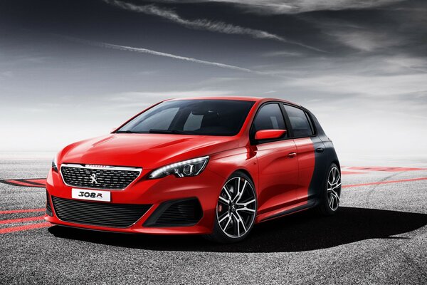 Auto Peugeot rossa e nera sulla strada