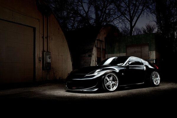 A black car parked on the sidewalk