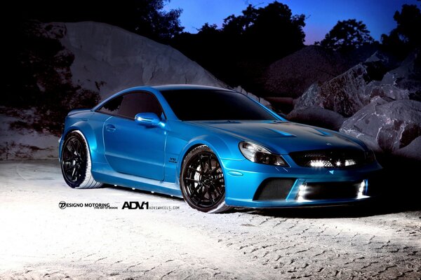 Blue car among the rocks at dusk