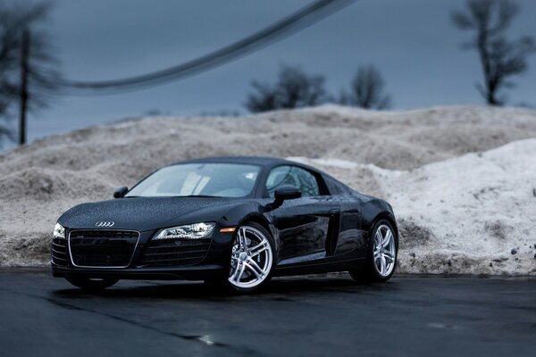 Black audi on the background of sandy mountains