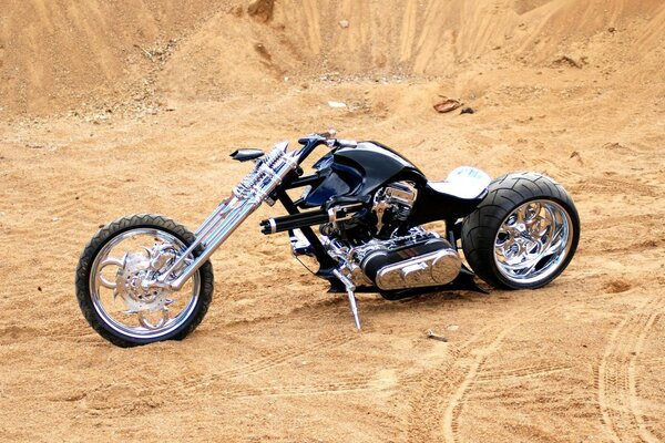 A black bike standing in the desert