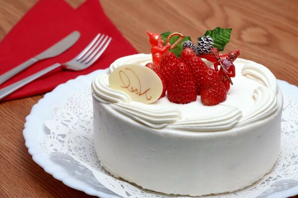 White dessert with strawberries and white chocolate on an openwork napkin