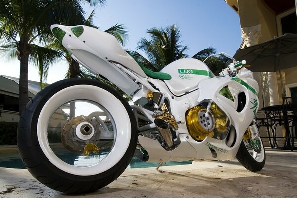 White motorcycle by the pool