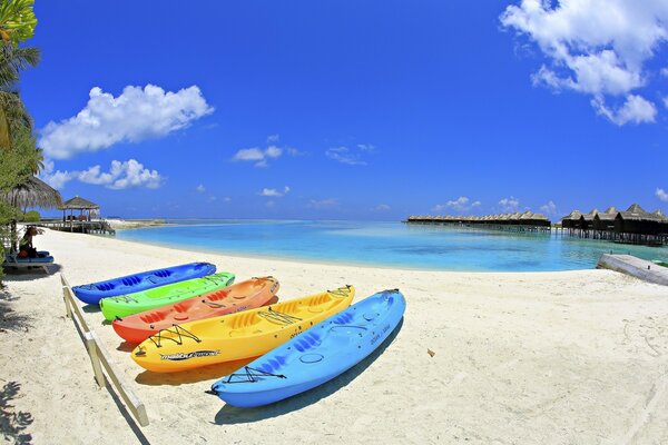 Colorful boats on a white beach