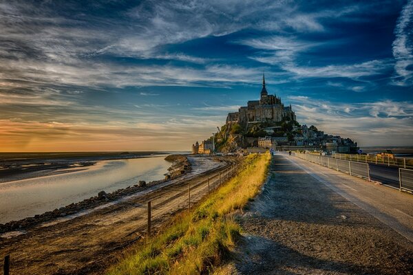 French castle in the distance at sunset