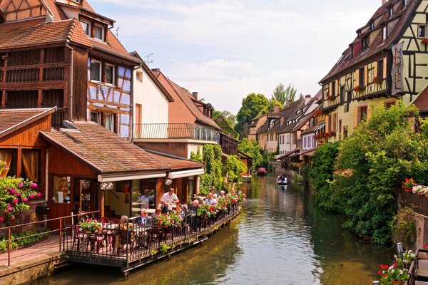 A river in France in the middle of a street, a blooming street