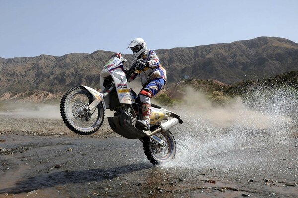 Biker on a motorcycle on one wheel