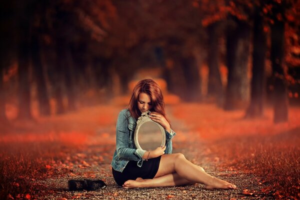 A beautiful girl in the autumn forest