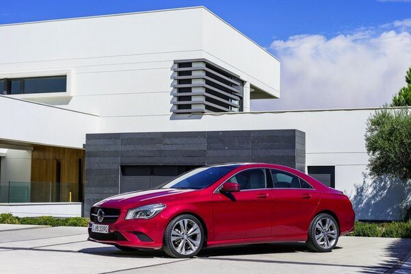 Red Mercedes and a techno-style building