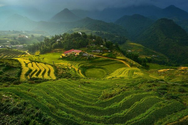 Landscape green cultivated lands and mountains in the distance