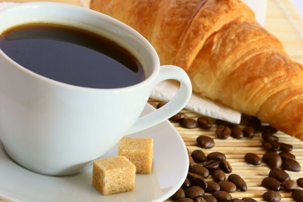 Coffee with croissant for breakfast at dawn