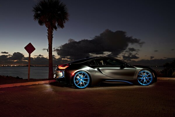 A car on blue disks against the night sky