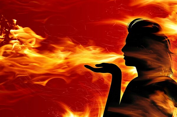 Silhouette of a girl blowing fire