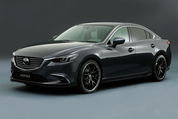 A black mazda car standing on a gray background