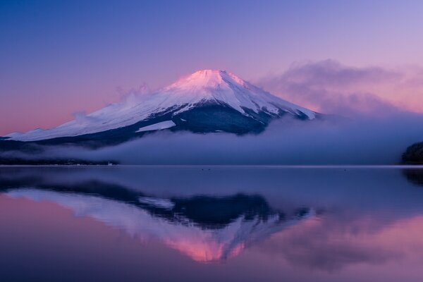 Mountain peak at sunset, above the water