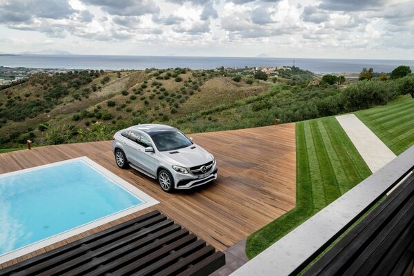 Car by the pool on the background of a mountain landscape